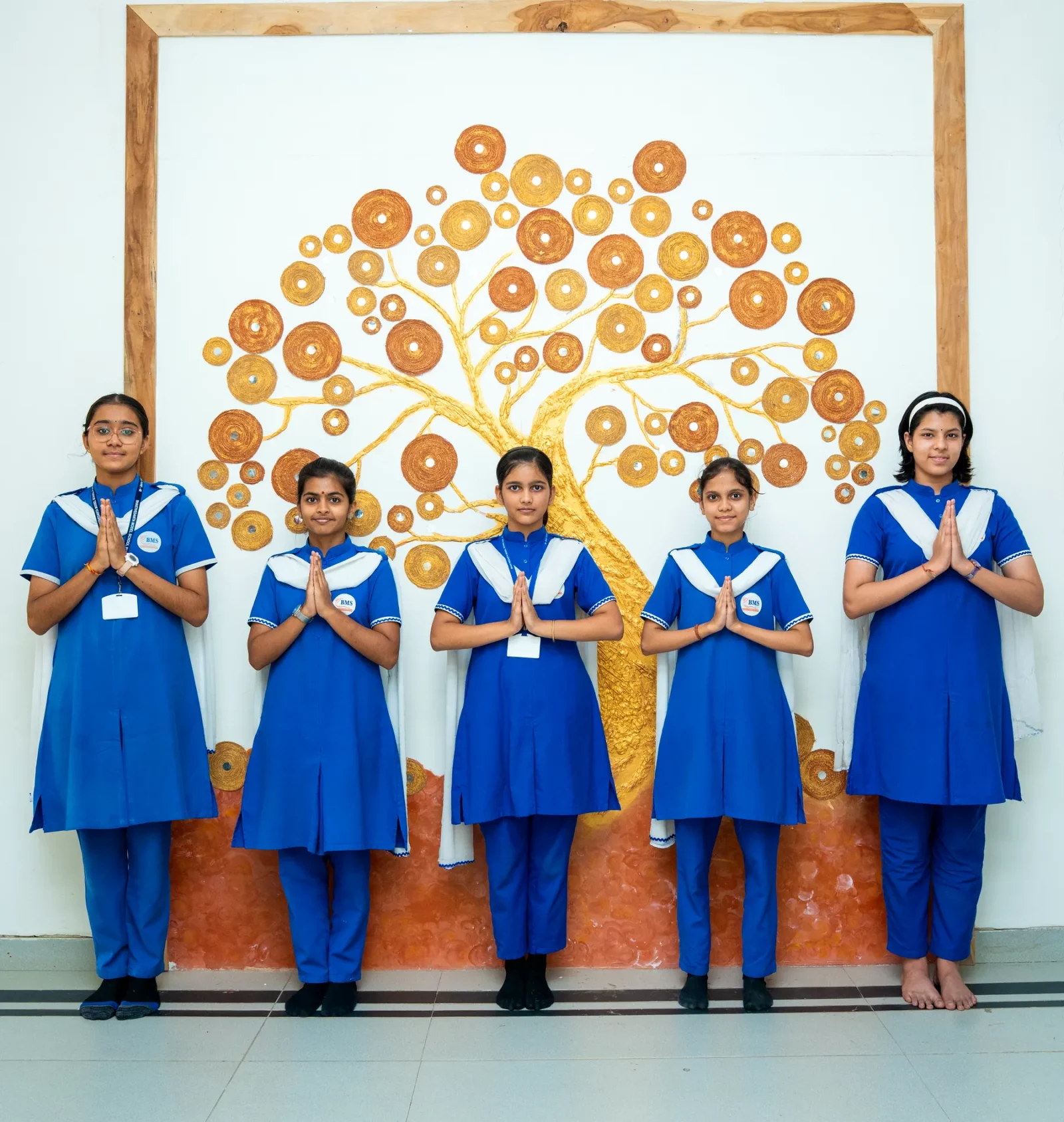 Students beside an art display they made