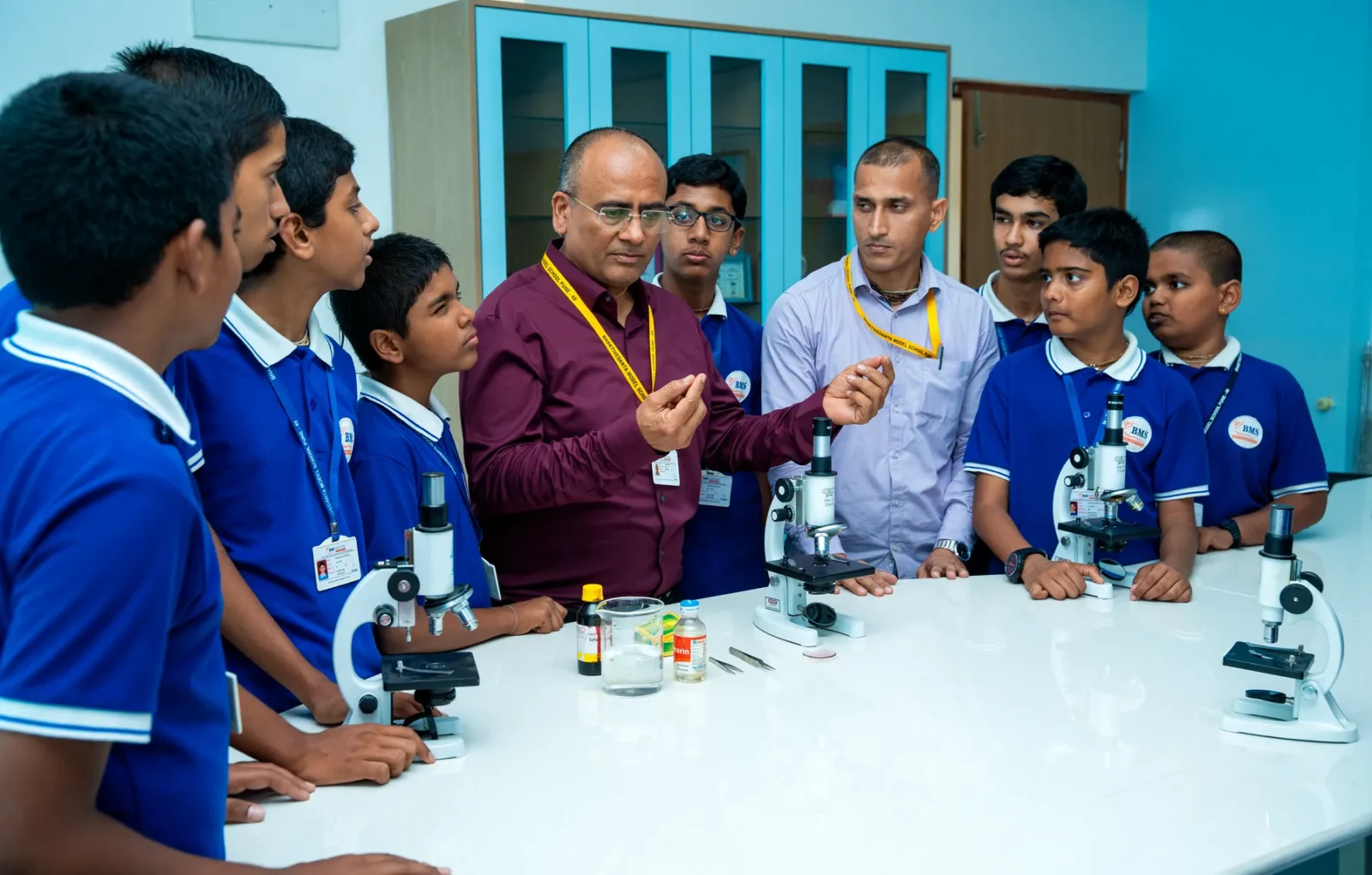 Students examining specimens under microscopes in the biology laboratory