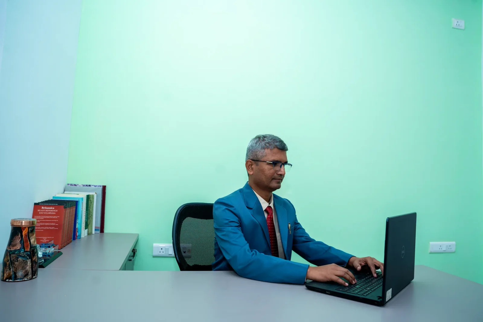 The Chairman at the desk in the Chairman's office