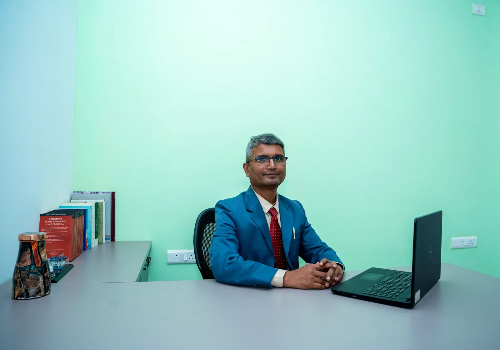 The Chairman of Bhaktivedanta Model School at his desk