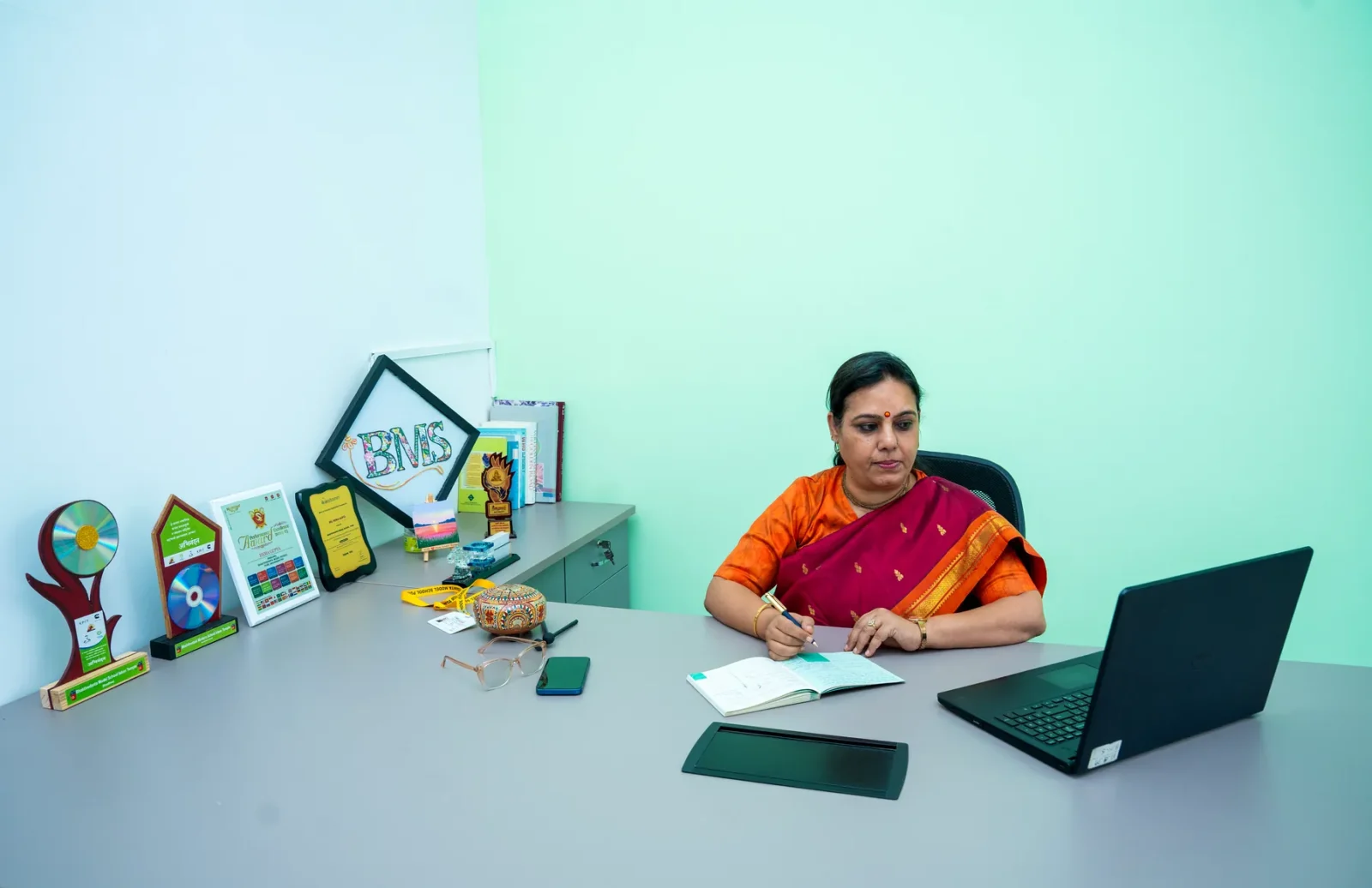 A counsellor working with two students at a table with learning aids in the counselling room