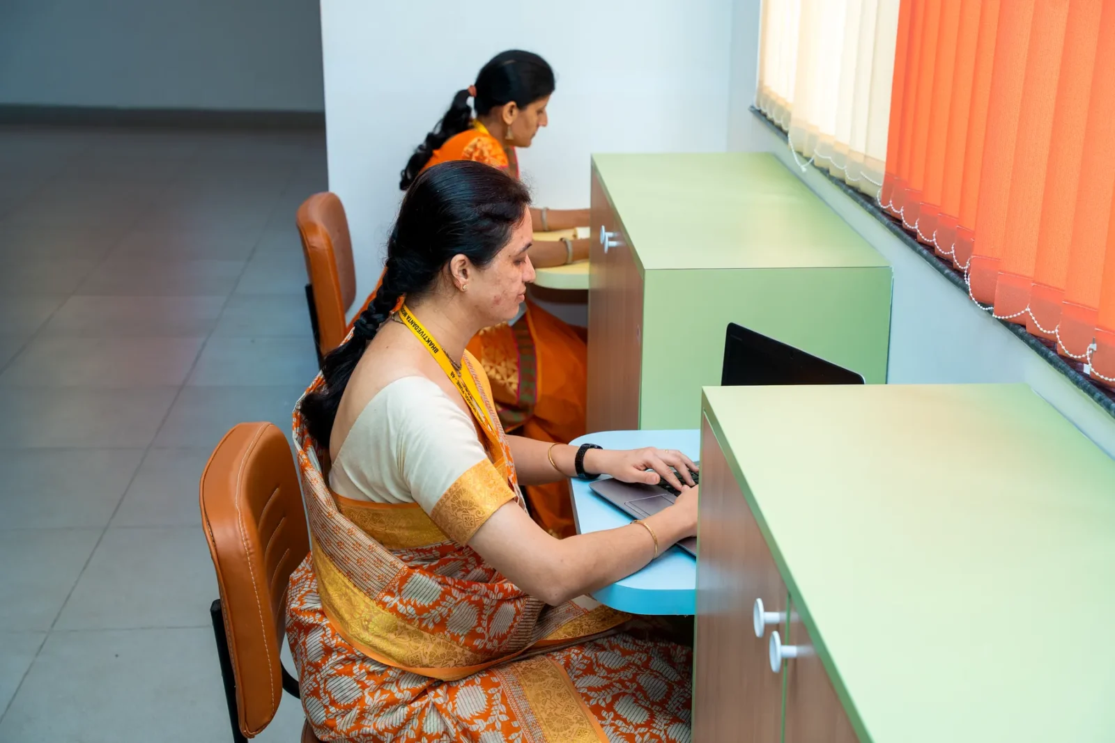 A teacher at an individual study station in the English language lab