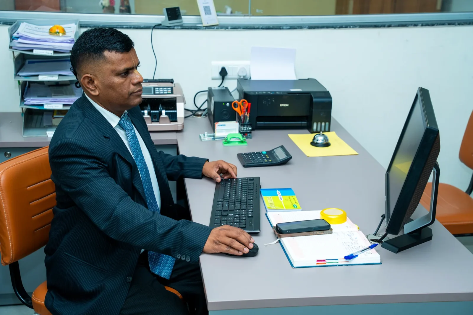 A member of the administrative staff at his desk in the examination office