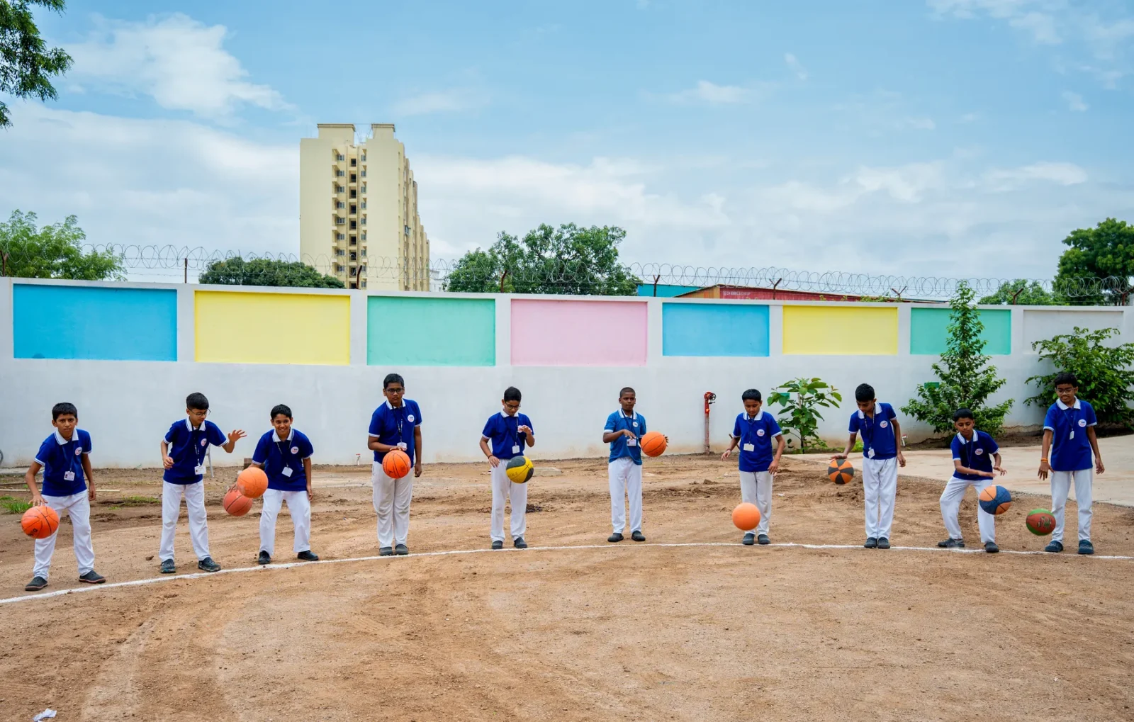 Students lined up on the ground for a house-system activity