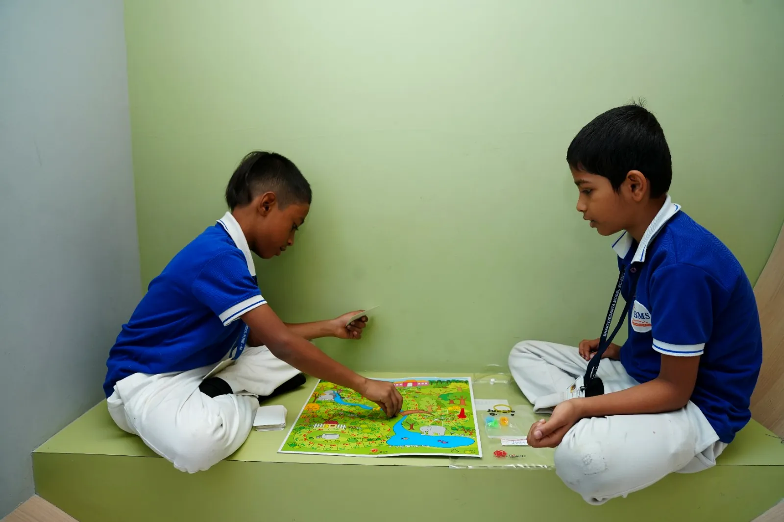 Two students playing a strategy board game during the games period