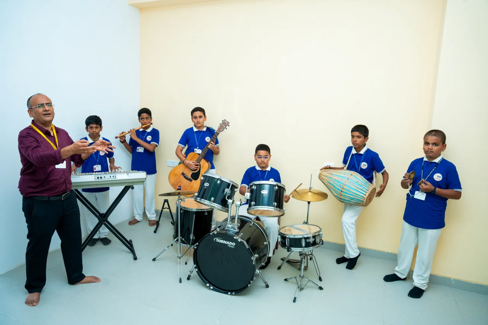 Students playing the tabla and drums together in the music room