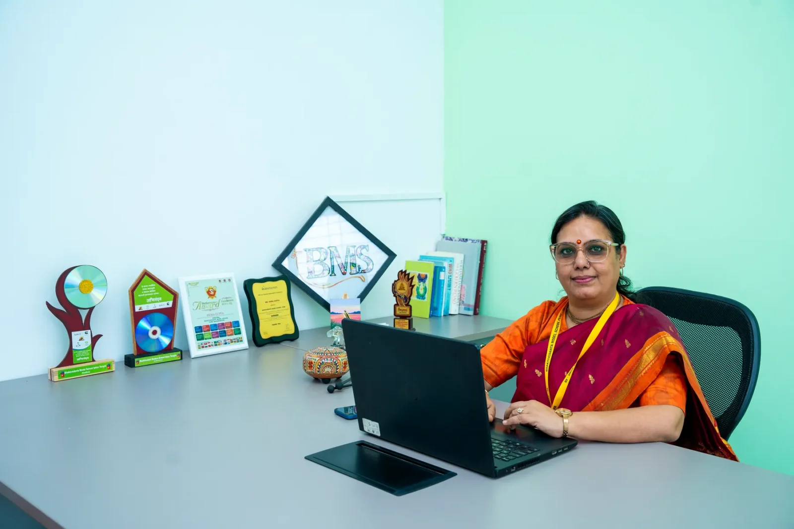 The Principal at the desk in the Principal's office