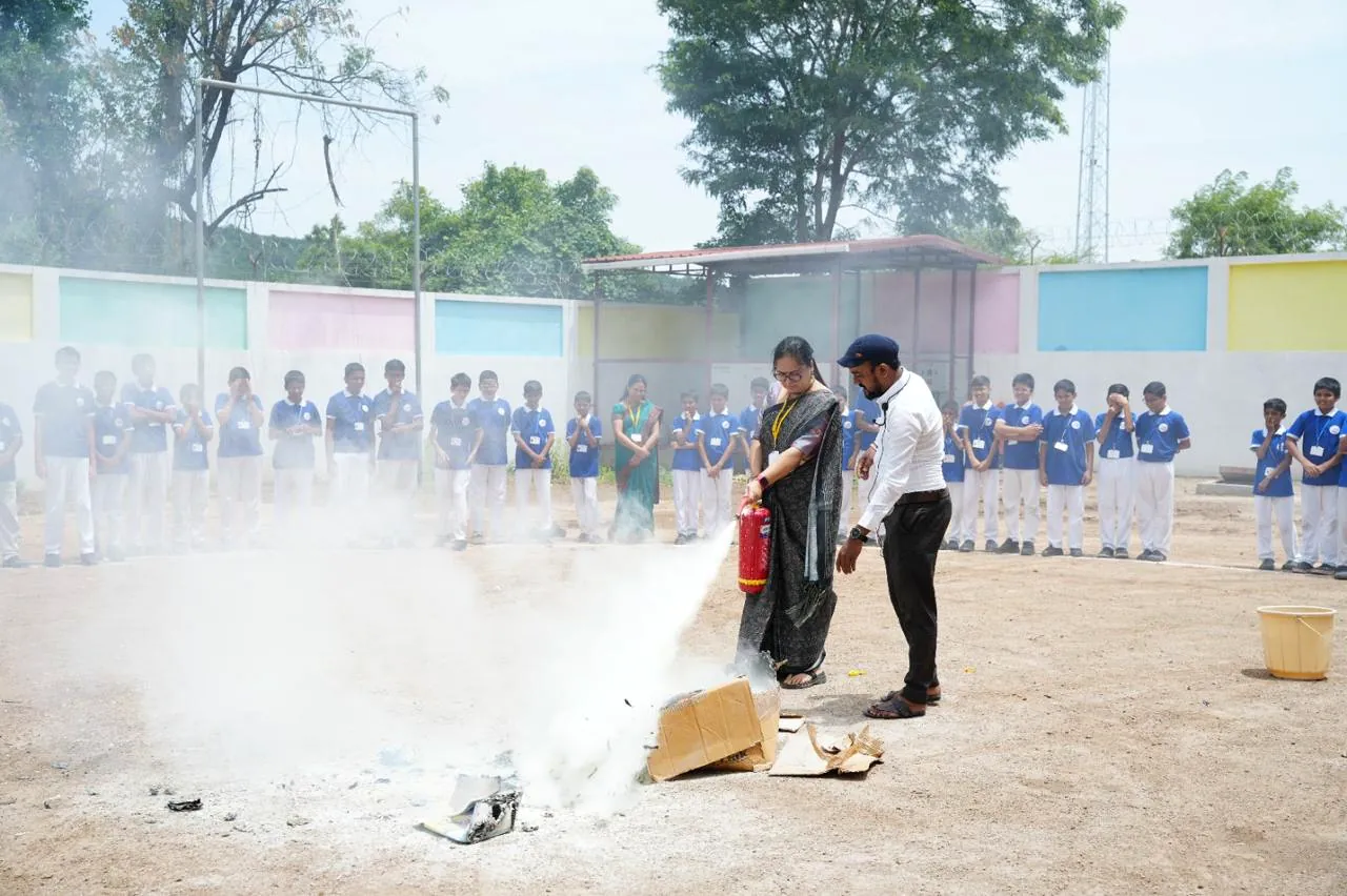 The whole school watching an extinguisher demonstration during a fire drill