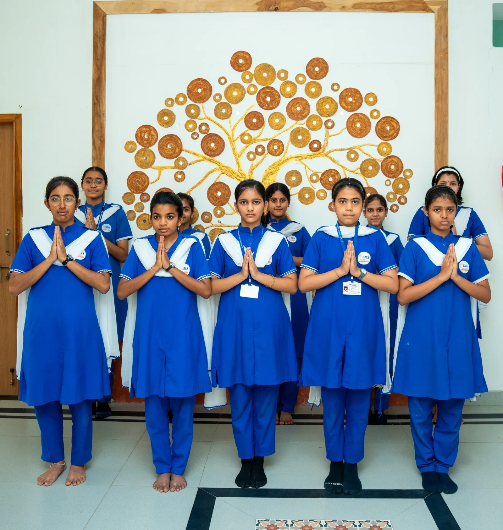 Students in the school uniform standing together for assembly