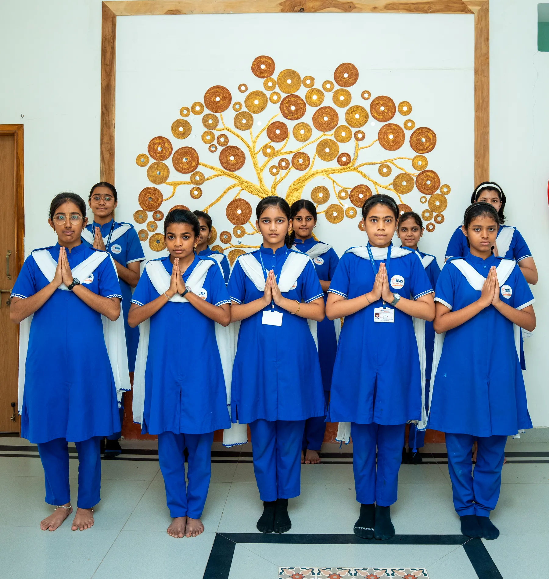 Students in the school uniform standing together for assembly