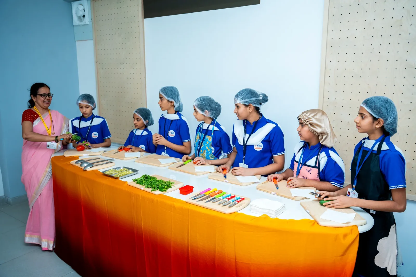 Students in aprons taking part in a cooking activity as part of skill subjects